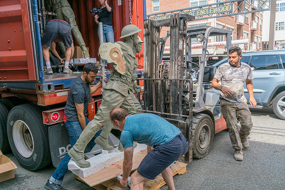 Sabin and Charlie unloading sculptures